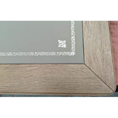 559 - DESK, 135cm W x 91cm D x 76cm H, limed oak with an inlaid grey leather writing surface.