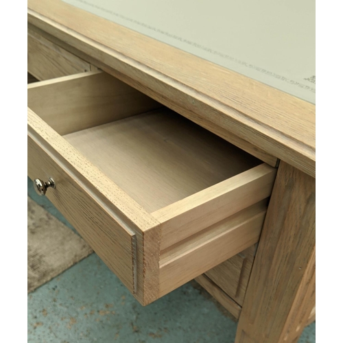 559 - DESK, 135cm W x 91cm D x 76cm H, limed oak with an inlaid grey leather writing surface.