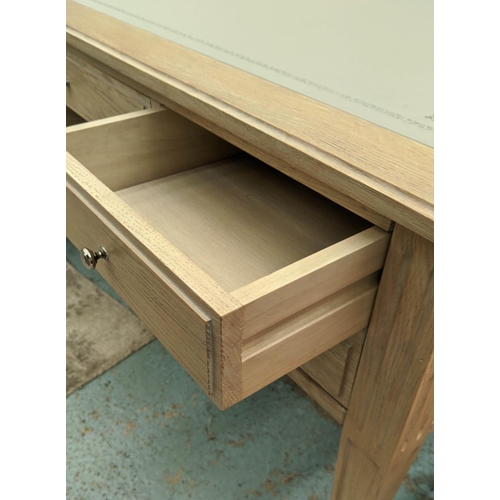 559 - DESK, 135cm W x 91cm D x 76cm H, limed oak with an inlaid grey leather writing surface.