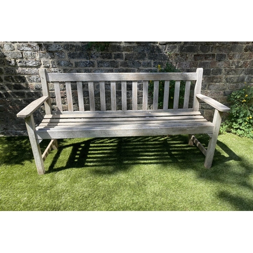 588 - GLOSTER GARDEN BENCH, silvery weathered teak of slatted form with flat top arms, 159cm W.