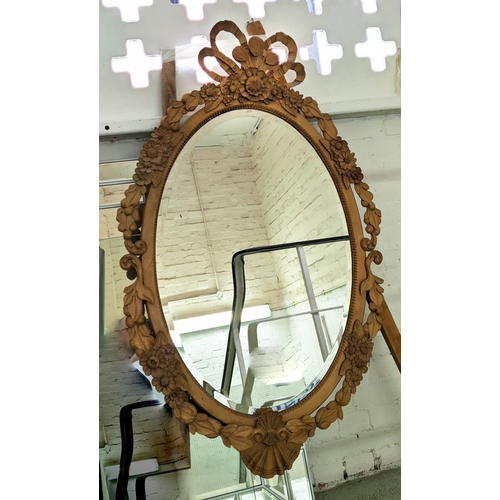 119 - WALL MIRROR, 86cm x 134cm H, with a carved wooden frame and oval bevelled plate.