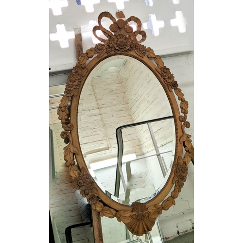 119 - WALL MIRROR, 86cm x 134cm H, with a carved wooden frame and oval bevelled plate.