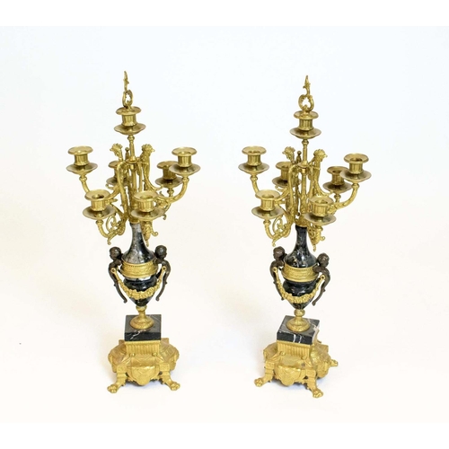 44 - CANDELABRA, a pair, Italian brevettato gilded metal seven branch with black marble and putto detail.... 