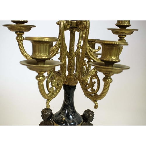 44 - CANDELABRA, a pair, Italian brevettato gilded metal seven branch with black marble and putto detail.... 