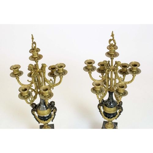 44 - CANDELABRA, a pair, Italian brevettato gilded metal seven branch with black marble and putto detail.... 