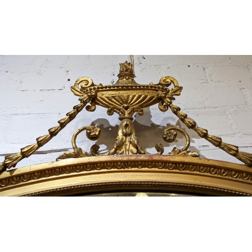 346 - WALL MIRROR, 89cm H x 107cm W, Victorian giltwood,  with oval bevellled plate and urn crest.