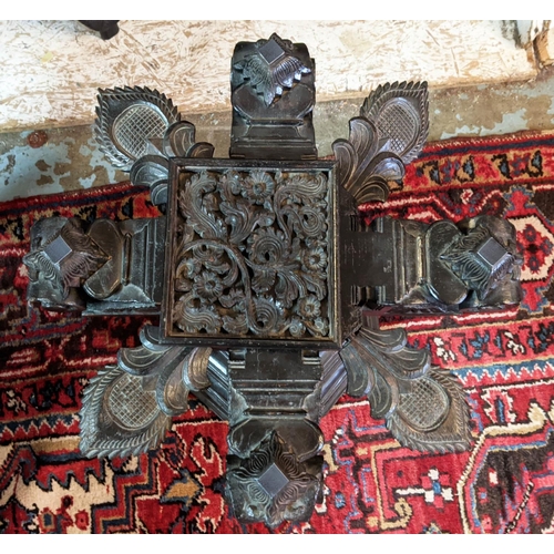 266 - LOW TABLE, Indian ebonised with revolving support and hexagonal glass top, 61cm x 61cm x 48cm H.