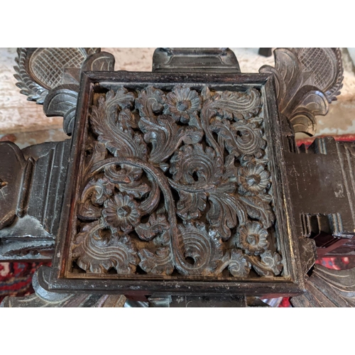 266 - LOW TABLE, Indian ebonised with revolving support and hexagonal glass top, 61cm x 61cm x 48cm H.