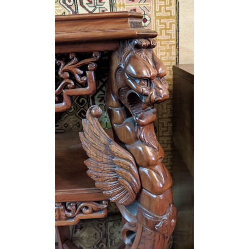 267 - JARDINIERE STAND, carved walnut in Chinese taste with decorative mythical winged beasts, 50cm W x 50... 