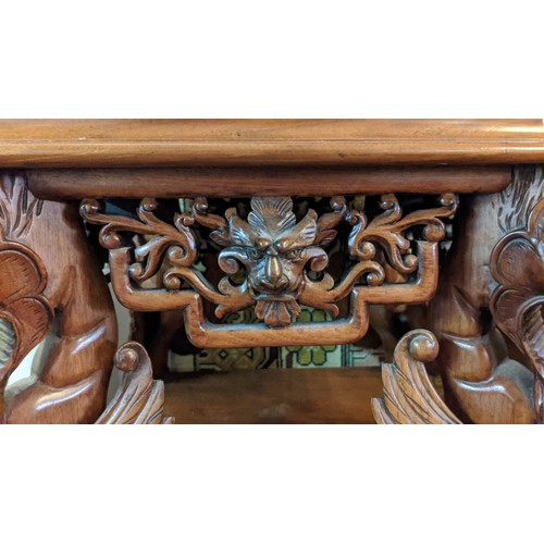 267 - JARDINIERE STAND, carved walnut in Chinese taste with decorative mythical winged beasts, 50cm W x 50... 