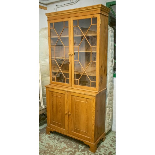 241 - BOOKCASE, late 20th century, Georgian style, pine of two glazed doors enclosing divided adjustable s... 