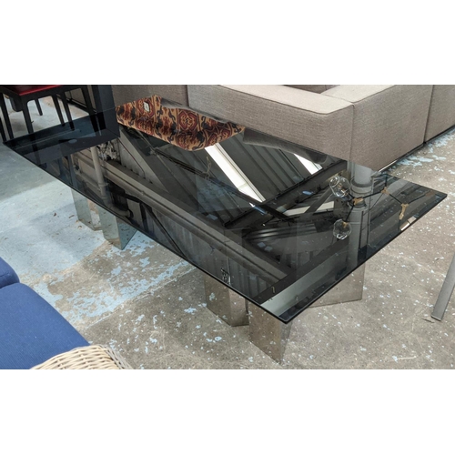 414 - ANDREW MARTIN COFFEE TABLE, the smoked glass top on polished X shaped metal bases, 90cm x 180cm L.