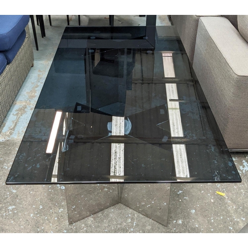 414 - ANDREW MARTIN COFFEE TABLE, the smoked glass top on polished X shaped metal bases, 90cm x 180cm L.