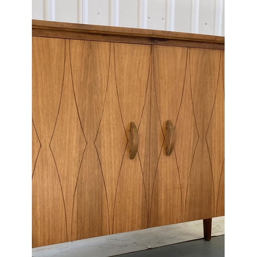 336 - SIDEBOARD, 1960s walnut, with two lozenge incised doors enclosing fitted drawers, by Everest, 129cm ... 