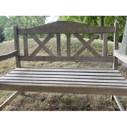 235 - GARDEN BENCH, silvery weathered teak with double 'X' back, 119cm W.