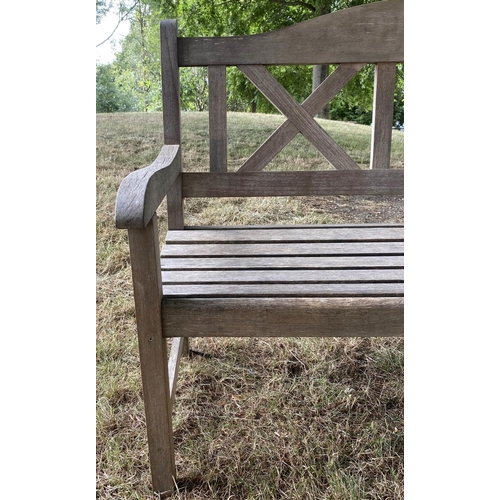 235 - GARDEN BENCH, silvery weathered teak with double 'X' back, 119cm W.