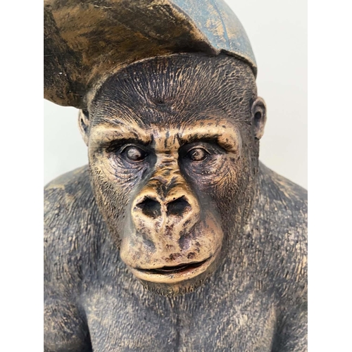 478 - GORILLA WITH BASEBALL CAP, resin with painted finish, 58cm x 40cm x 34cm.