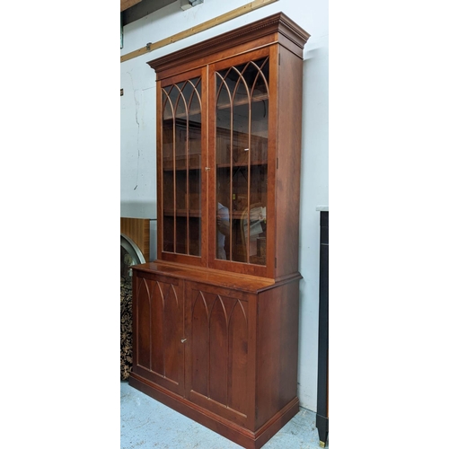 498 - BOOKCASE, cherrywood, gothic astrical detail, 244cm H x 117cm W x 53cm D.