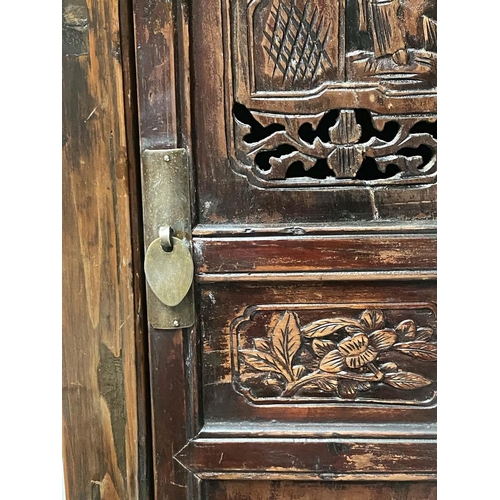 294 - CHINESE MARRIAGE CABINET, 19th century Chinese lacquered with four hinged carved and pieced doors en... 