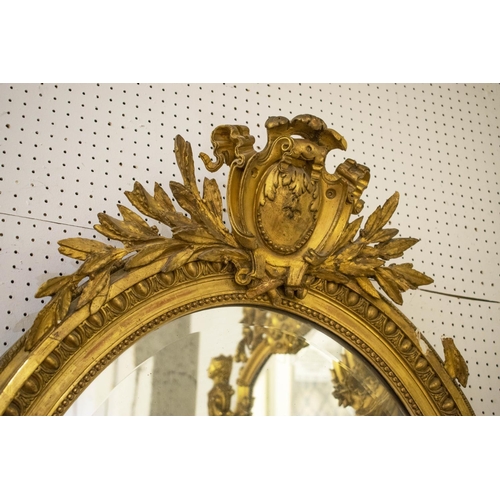 154 - WALL MIRROR, circa 1880, French giltwood and gesso with old oval bevelled plate and cartouche surmou... 