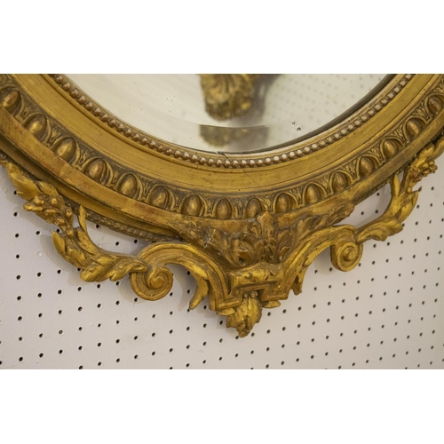 154 - WALL MIRROR, circa 1880, French giltwood and gesso with old oval bevelled plate and cartouche surmou... 