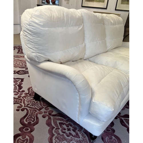 165 - HOWARD STYLE SOFA, three seater, feather filled with turned front supports and castors, 198cm W.