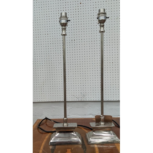 391 - TABLE LAMPS, a set of three, 50cm H, slender form, polished metal. (3)