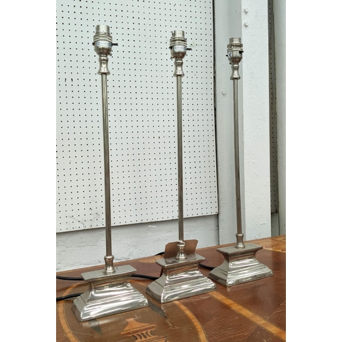 391 - TABLE LAMPS, a set of three, 50cm H, slender form, polished metal. (3)