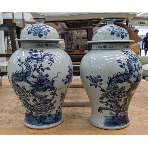 316 - TEMPLE JARS, a pair, Chinese export style, blue and white ceramic, dragon decoration, 39cm H. (2)