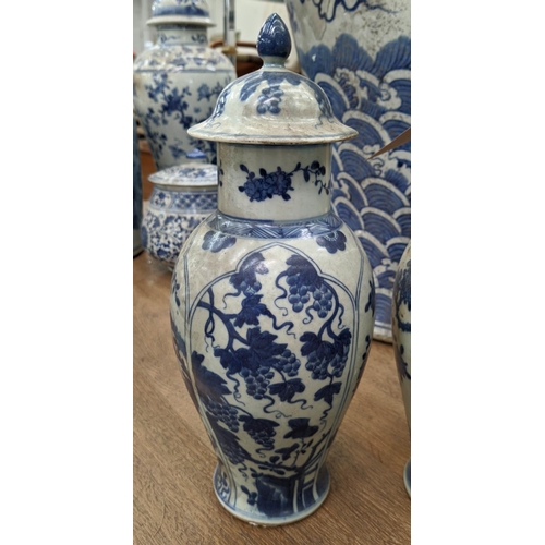 320 - VASES WITH COVERS, a set of four Chinese export style, blue and white ceramic and another of differi... 