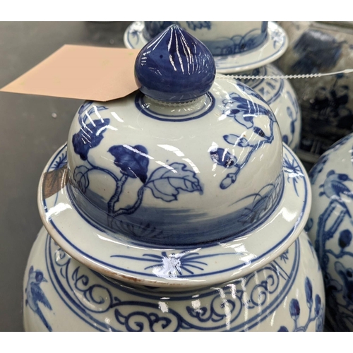 330 - TEMPLE JARS, a set of three, Chinese export style, blue and white ceramic, cherry blossom decoration... 