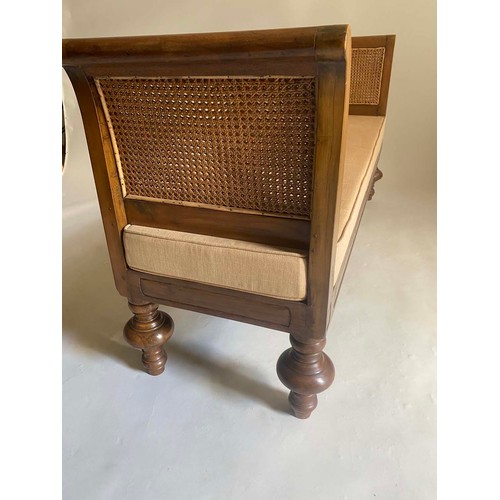 301 - DAYBED, 20th century teak, with scroll arms, cane paneling, fitted cushion and turned supports, 170c... 