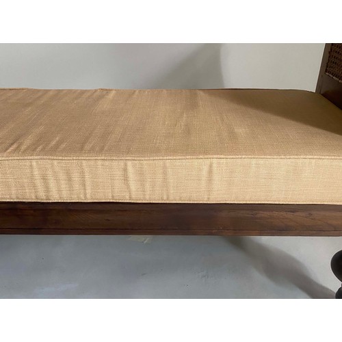 301 - DAYBED, 20th century teak, with scroll arms, cane paneling, fitted cushion and turned supports, 170c... 