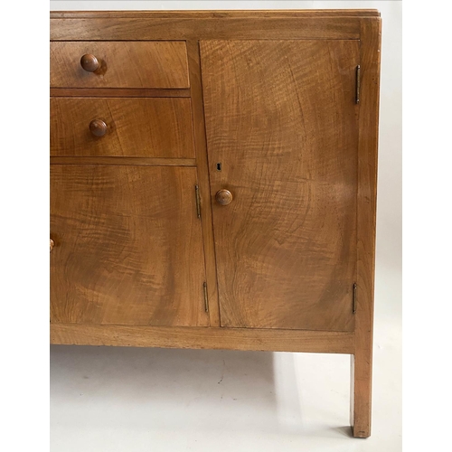 504 - HEALS SIDEBOARD, 1950s figured walnut, with drawers and cupboards flanked by further cupboards, labe... 