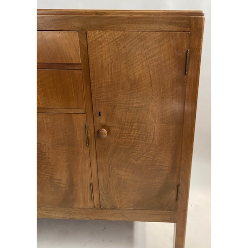 504 - HEALS SIDEBOARD, 1950s figured walnut, with drawers and cupboards flanked by further cupboards, labe... 