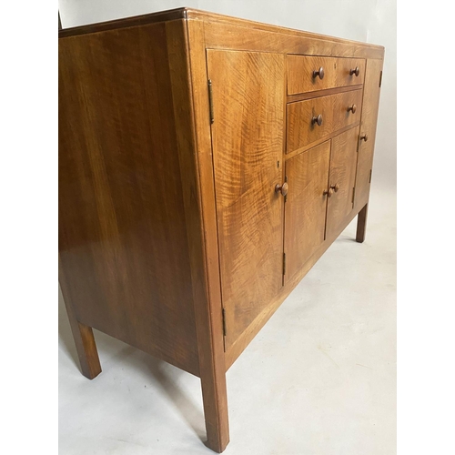 504 - HEALS SIDEBOARD, 1950s figured walnut, with drawers and cupboards flanked by further cupboards, labe... 