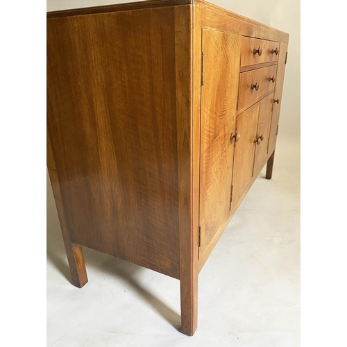 504 - HEALS SIDEBOARD, 1950s figured walnut, with drawers and cupboards flanked by further cupboards, labe... 