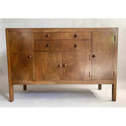 504 - HEALS SIDEBOARD, 1950s figured walnut, with drawers and cupboards flanked by further cupboards, labe... 