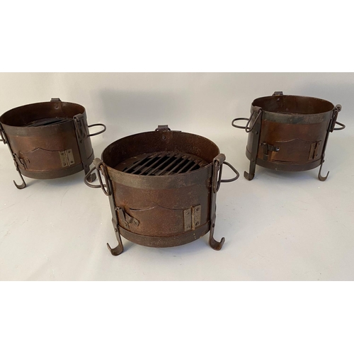 510 - SMALL FIRE PITS, each of two handled form, raised on three feet, 22cm x 36cm x 25cm. (3)