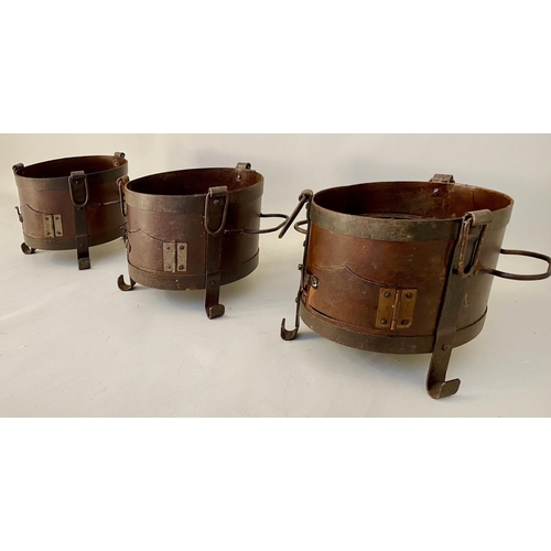 510 - SMALL FIRE PITS, each of two handled form, raised on three feet, 22cm x 36cm x 25cm. (3)