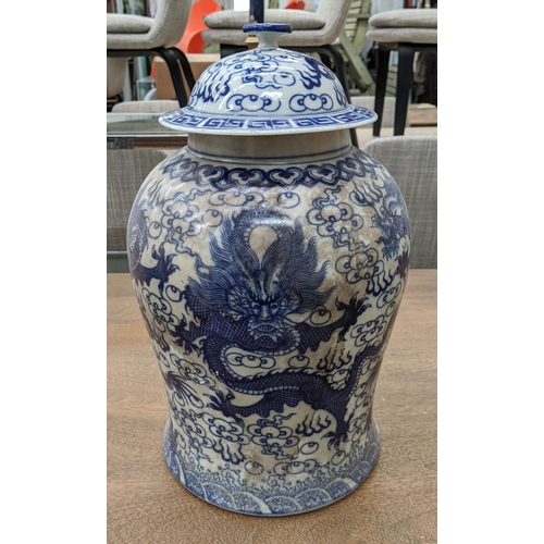 318 - TEMPLE JARS, a set of three Chinese export style, blue and white ceramic, dragon decoration, 44cm at... 