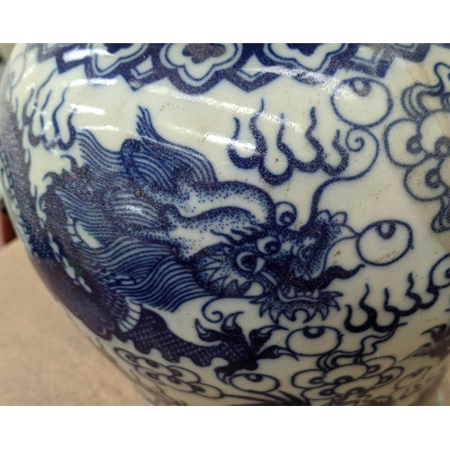 318 - TEMPLE JARS, a set of three Chinese export style, blue and white ceramic, dragon decoration, 44cm at... 