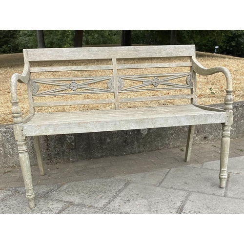 287 - COLONIAL STYLE GARDEN BENCH, weathered teak with carved back, slatted seat and downswept arms, 115cm... 