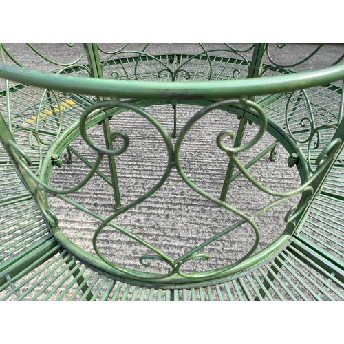 470 - ARCHITECTURAL GARDEN TREE BENCH, antiqued green painted finish 77cm x 140cm x 140cm.