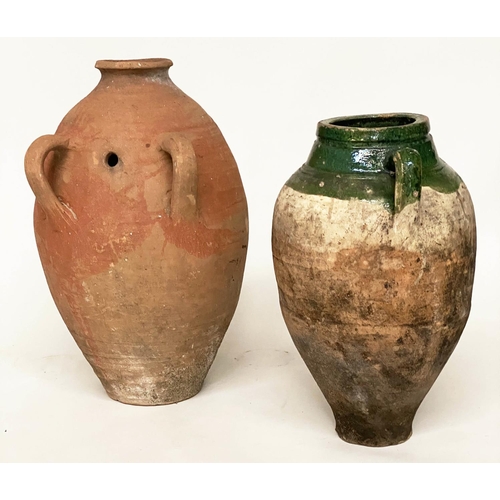 103 - OLIVE JARS, two Mediterranean terracotta of typical form, one with green glaze, 65cm H x 53cm H. (2)