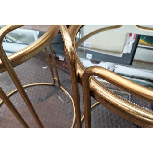 249 - SIDE TABLES, a pair, 64cm x 48cm diam., 1970s Italian style, gilt metal, mirrored top. (2)