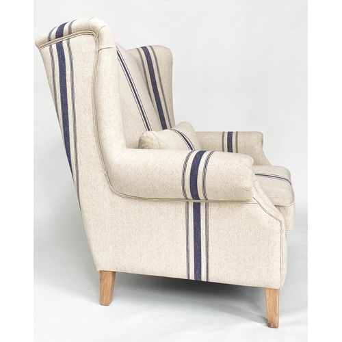 99 - WING ARMCHAIR BY COX AND COX, striped linen upholstered wide seat with tapering square oak supports,... 