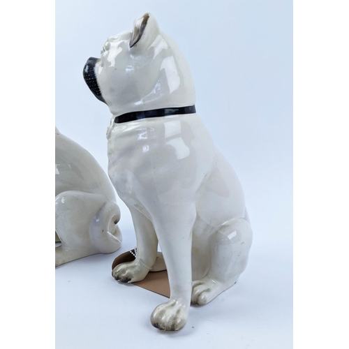 18 - STAFFORDSHIRE PUG DOGS, an opposing pair, late 19th century, 27cm H.