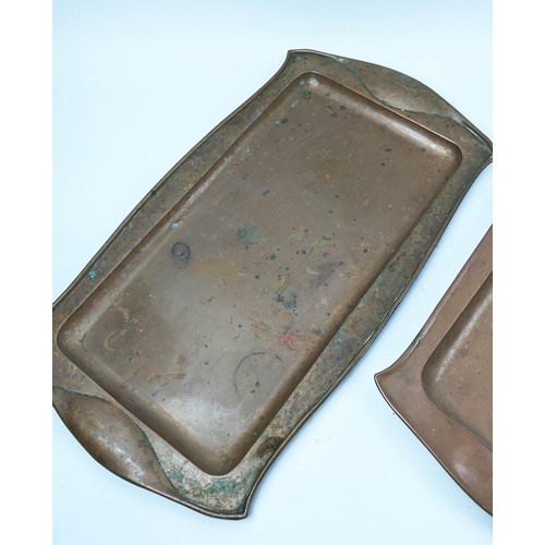 31 - NEWLYN SCHOOL BRASS ARTS AND CRAFTS TRAY, along with two shaped copper serving trays, 54cm x 20cm W.... 