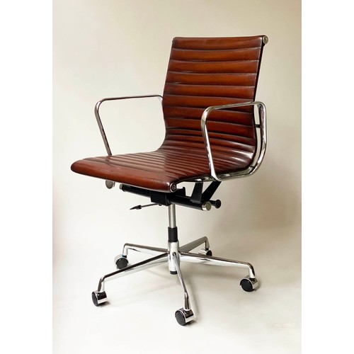 111 - REVOLVING DESK CHAIR, Charles and Ray Eames inspired ribbed, mid brown leather, revolving and reclin... 